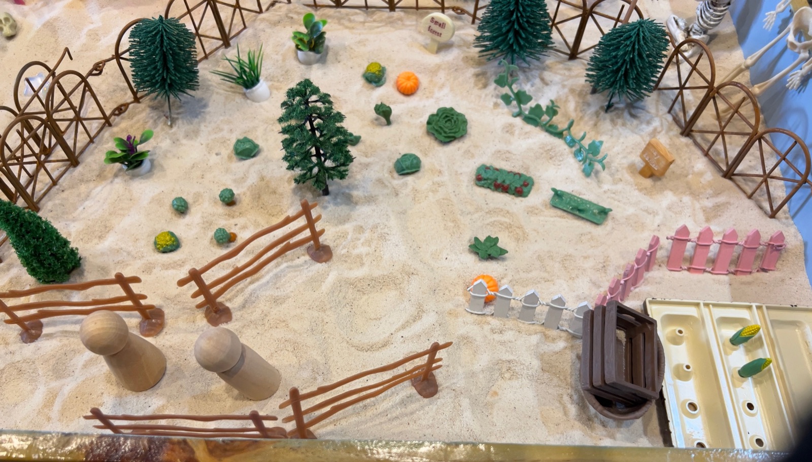 Miniature figures arranged in a sandtray